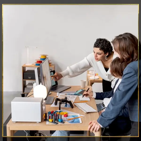 Professionals collaborating in office, framed by letter-shaped windows